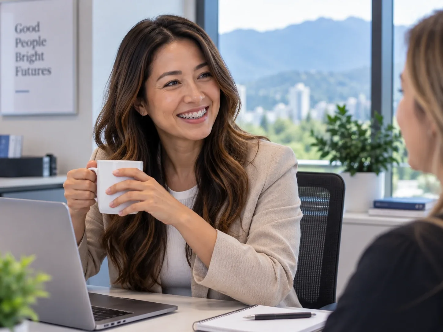Adult professional with ceramic braces smiling during a conversation at work.
